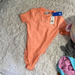 Adidas bodysuit, never been worn before, and a coral color.